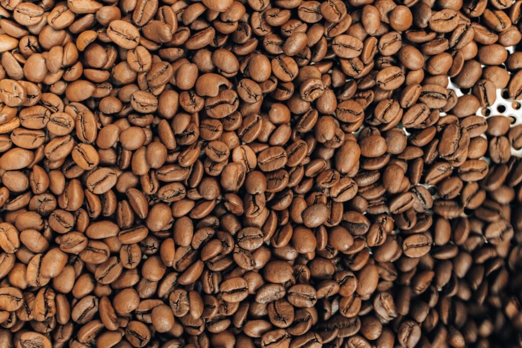 Detailed close-up of roasted brown coffee beans showcasing their texture and natural color.